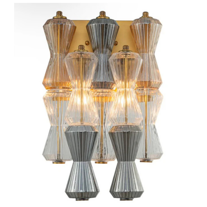 Decorative wall sconce with multiple glass shades on a white background